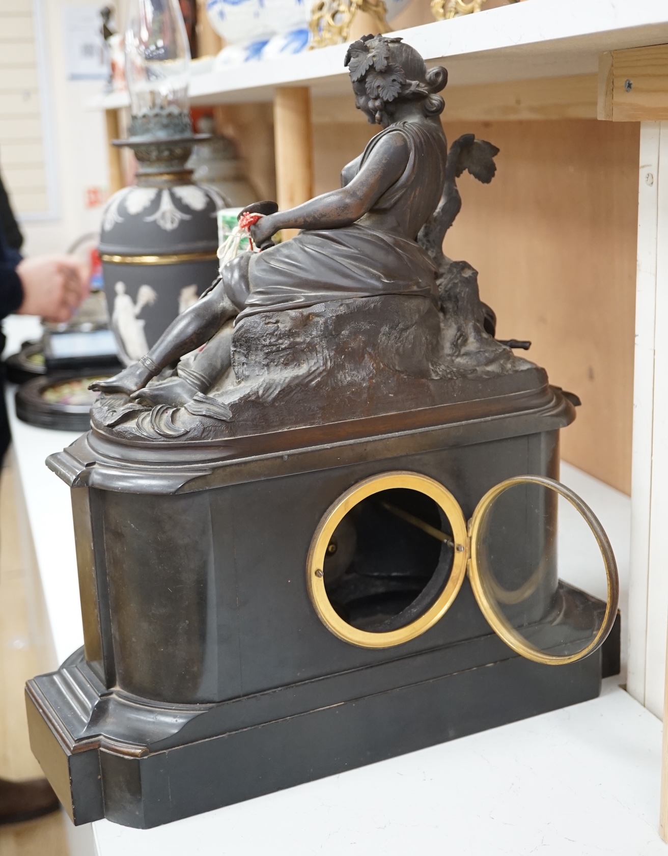 A Victorian black marble eight day mantel clock, surmounted by a cast bronze figure of a muse, with key, 48cm high. Condition - fair, untested